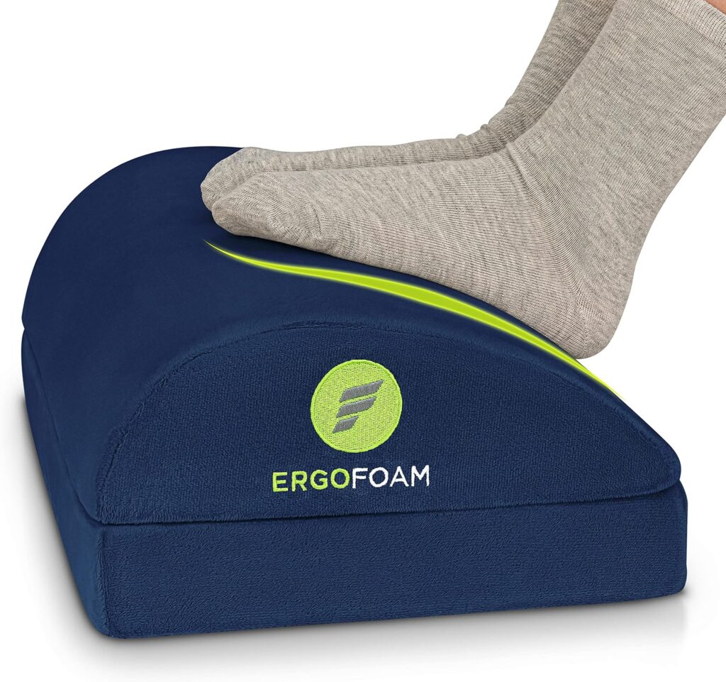 Navy blue adjustable teardrop shaped foot rest with velvet cover under a desk