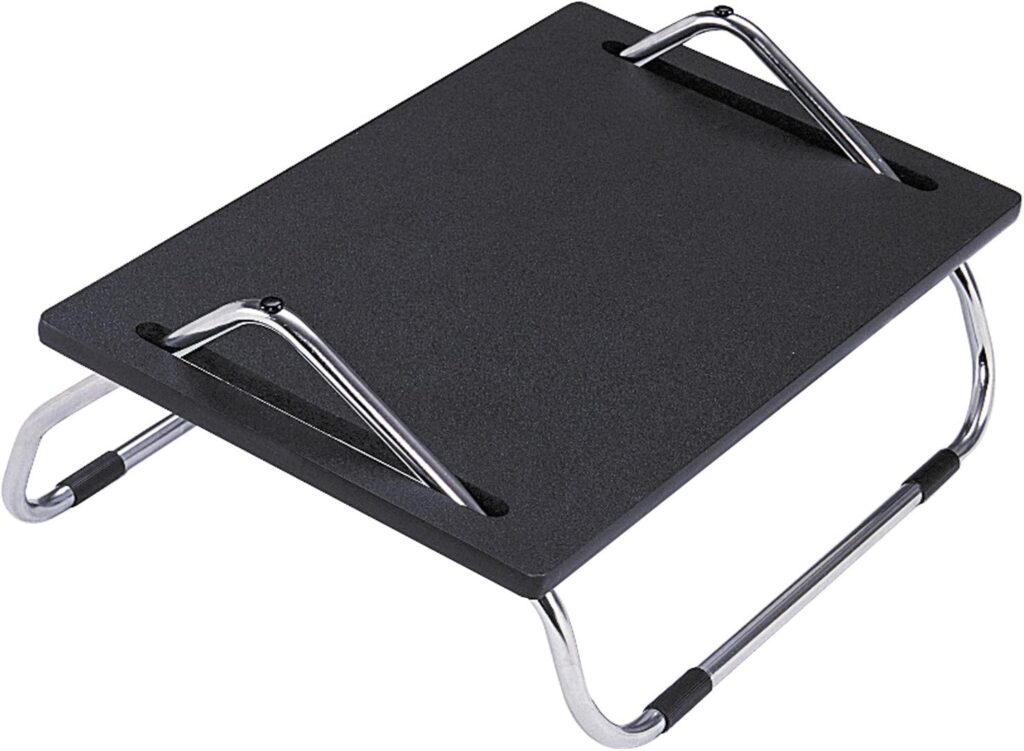 Safco steel chrome footrest with sliding tilt angle in an office workspace